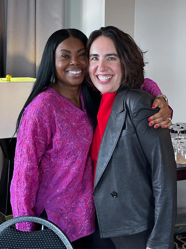 woman smiling while standing in garden
