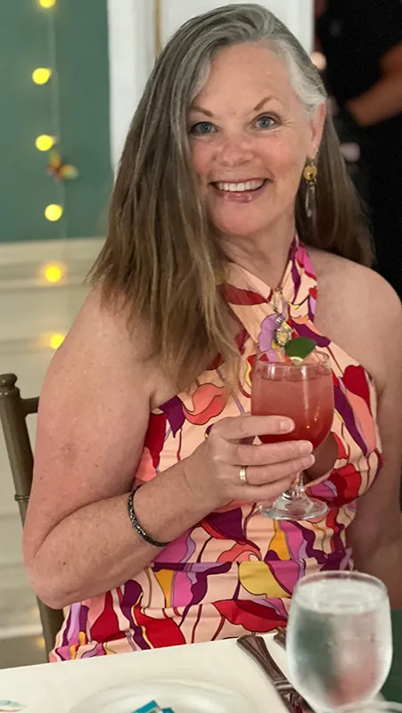 woman smiling while standing in garden