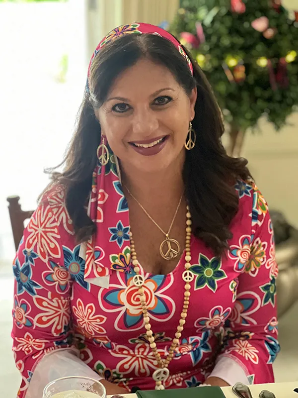 woman smiling while standing in garden